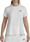 A woman wears the Bullpadel Picase Women's Padel T-Shirt in bone with a subtle navy logo on the left chest, paired with a matching white skirt. Her face isn’t visible in this Bullpadel performance padel outfit.