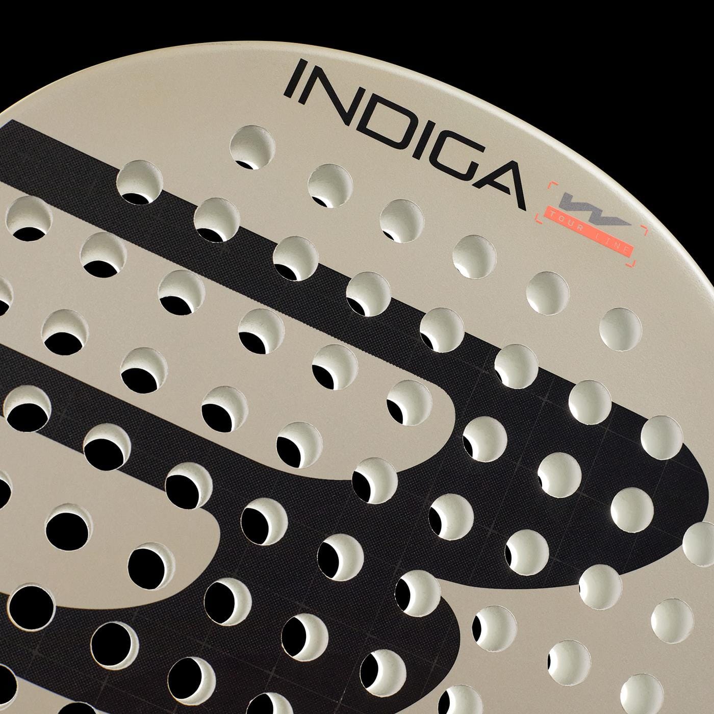 Close-up of the Bullpadel Indiga W 2026 Padel Racket, a lightweight beige racket with round holes and black graphic patterns. "INDIGA" and the logo appear near the edge, making it an ideal padel racket for women.