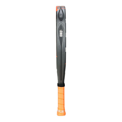 Side view of a sleek grey and orange Bullpadel Ionic Power 2025 padel racket. The frame features an engraved pattern, and the vibrant orange grip enhances performance, boasting IONIC POWER technology with a small Bullpadel logo visible.