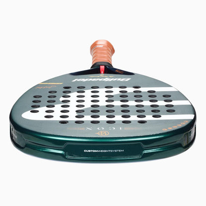 The Bullpadel Icon 2026 Padel Racket - Green features a perforated surface, orange grip, and white accents. Viewed from the handle end, its "Custom Weight System" is visible—a design inspired by Juan Martín Díaz.