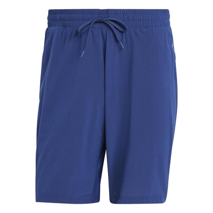 The ADIDAS Ergo Men's Padel Shorts in navy feature an elastic waistband and drawstring, crafted from recycled materials. The textured fabric ensures comfort without visible logos or patterns, perfect for eco-conscious individuals seeking lightweight shorts.