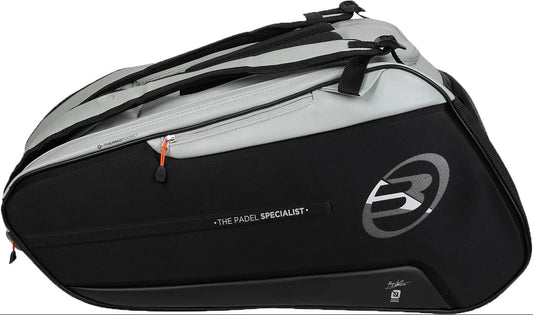 The Bullpadel BPP26013 Hack 2026 Padel Racket Bag - Grey is a large black and gray bag with multiple zippered and thermal racket compartments, "THE PADEL SPECIALIST" text, and a bold "B" logo on the side.