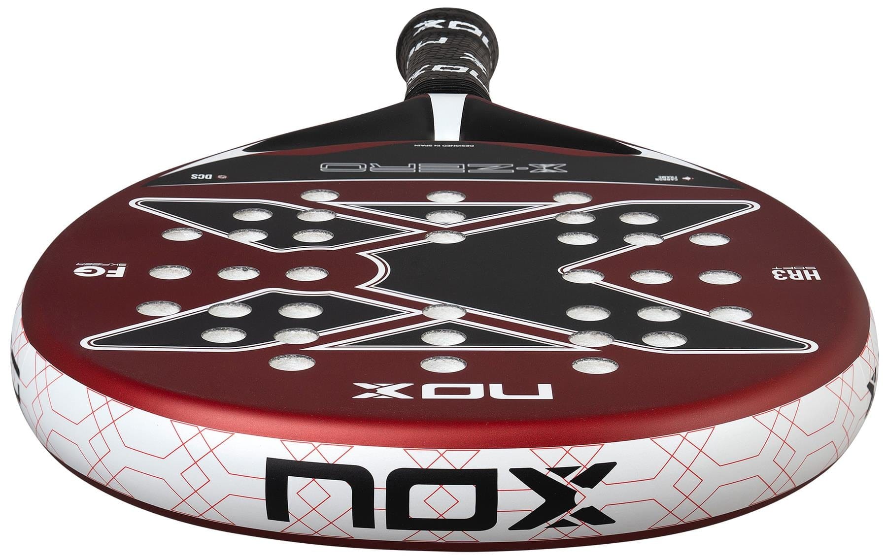 A close-up of the NOX X-Zero Red Padel Racket, featuring a striking red, black, and white design with a bold "X" and multiple round holes. The NOX brand logo is prominently displayed on this top control racket.