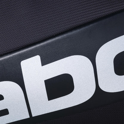 Close-up of the black surface of the Babolat RH Pro 4 Racket Padel Bag by Babolat, showing bold white letters from the logo against a textured background.
