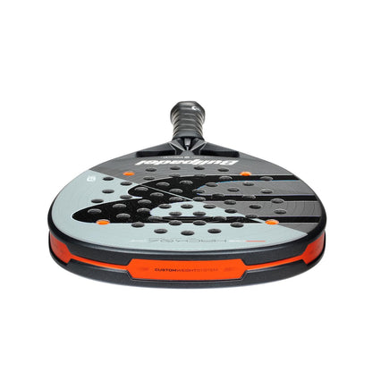 A front view of the Bullpadel HACK 04 Comfort 2026 Padel Racket - Grey features a rounded face with multiple holes, a short handle, and Bullpadel branding that emphasizes its dynamic power.