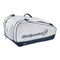 The Bullpadel Pearl 25 Padel Racket Bag in white, favored by Bea González, has a logo on the side, large size, multiple zippered compartments, carrying handles, and dark blue trim on the bottom edges.