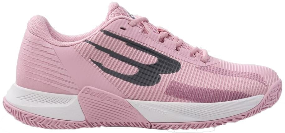 The Bullpadel Performance Comfort 26V Womens Padel Shoes in pink feature a textured sole, white midsole, and a standout black and purple logo, offering exceptional stability and comfort for padel with a secure lace-up design.