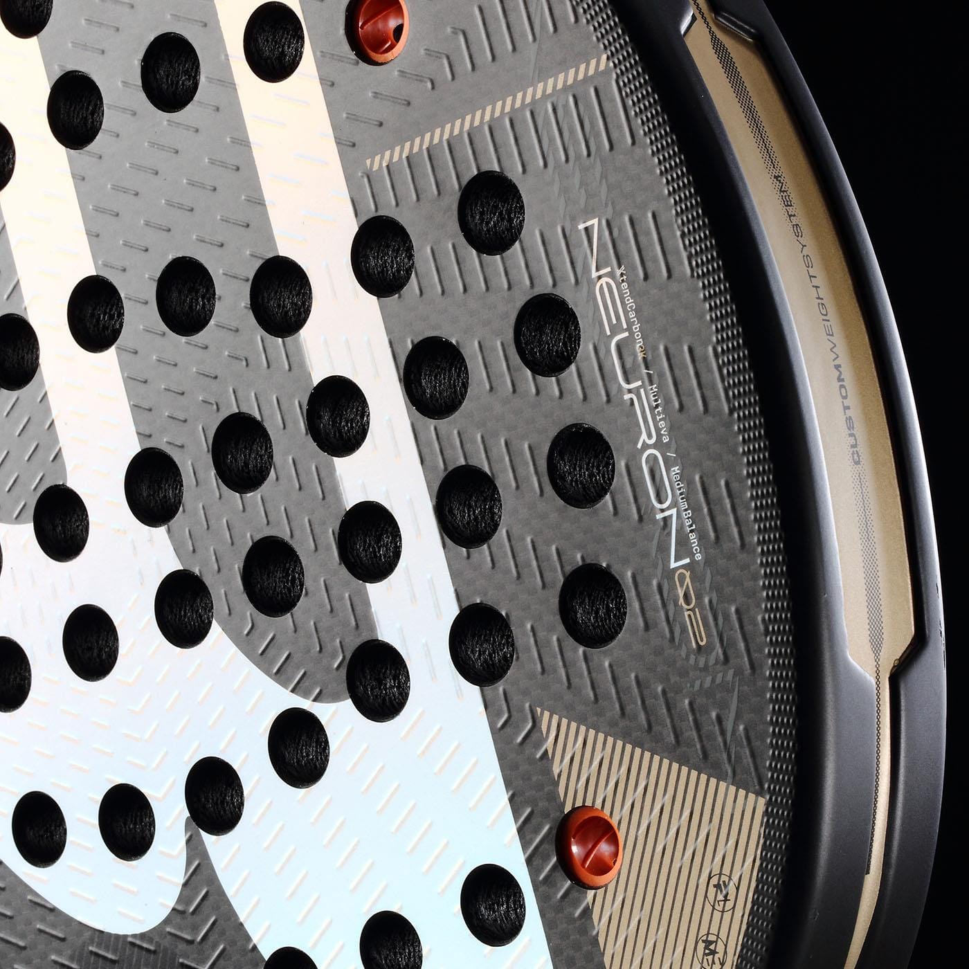 Close-up of the Bullpadel Neuron 02 2026 Padel Racket in black and gold, showcasing its hybrid shape, textured surface, circular holes, metallic gold accents, and bold Bullpadel branding for a professional look.