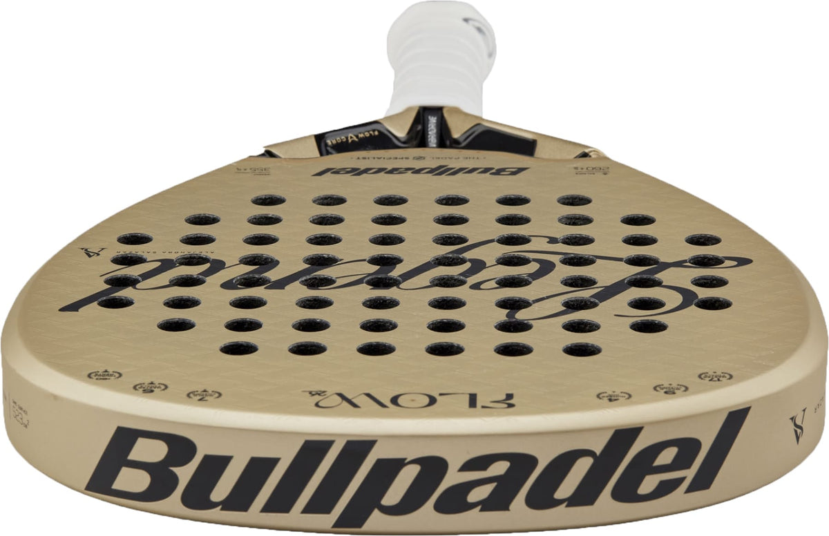 A Bullpadel Flow 2027 Padel Racket in gold, displaying a white grip, black Bullpadel logo, and round perforations on the face. The racket features a 3D Grain surface for enhanced control and is viewed from a low angle.