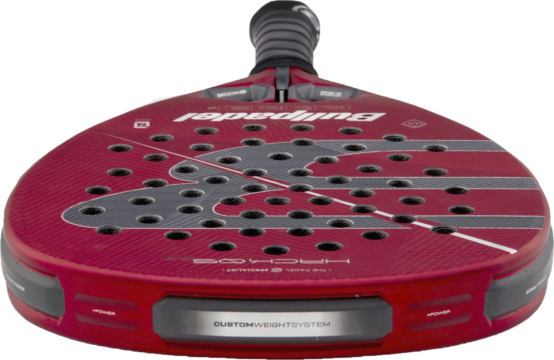 A close-up view of the red Bullpadel Hack 05 Comfort 2027 Padel Racket by Bullpadel highlights its perforated face, advanced Tricarbon 18K construction, custom weight system, and textured surface details, all featuring a responsive MultiEva core.