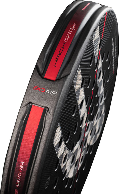 Close-up of a black and red Bullpadel padel racket displaying a textured surface, round holes, and branding such as “HACK 03 AIR” and “AIR POWER” along the side. The design incorporates advanced materials like Aluminized Carbon 18K for enhanced durability and performance, inspired by the innovation of the Bullpadel Hack 05 Hybrid 2027 Padel Racket.