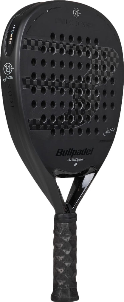 A Bullpadel Icon 2027 Padel Racket in black, showcasing a textured X-Tend Carbon 12K fiber design with a perforated face and a wrapped black handle. The MultiEva core delivers optimal performance, while the Bullpadel branding and logos are visible on the racket’s surface.