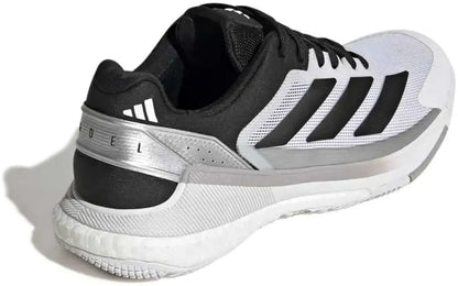 A rear-angled view showcases the adidas Crazyquick Boost Mens Padel Shoes in Cloud White, Core Black, and Silver Metallic—featuring three black stripes, silver highlights, and a textured sole. Designed for dynamic padel play, these shoes offer enhanced energy return for optimal on-court performance while delivering signature adidas style.
