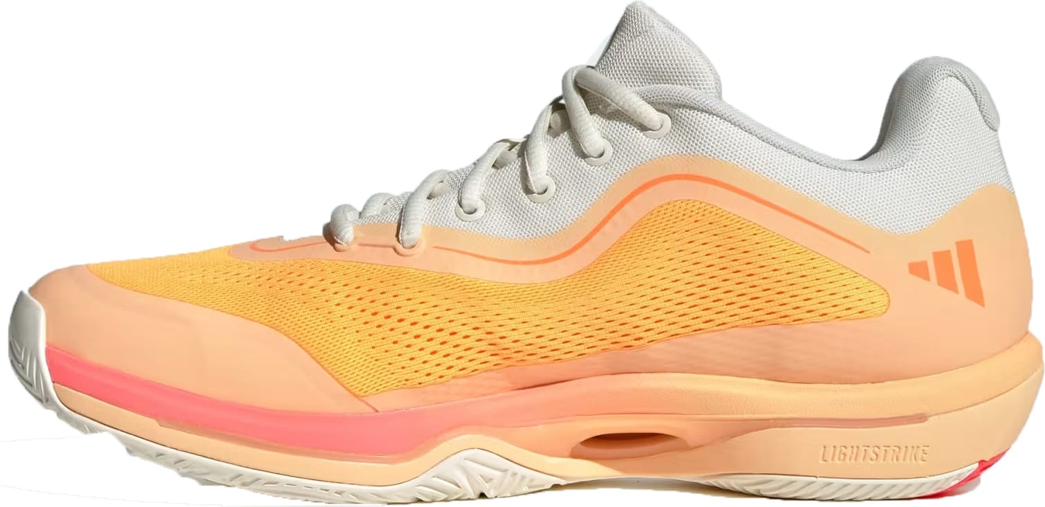 Side view of the adidas Crazyflight 7 Indoor Mens Padel Shoes in Lucid Tangerine, Lucid Orange, and Off White with white laces, mesh upper, textured sole featuring LightstrikePro cushioning, and a subtle adidas logo on the heel.