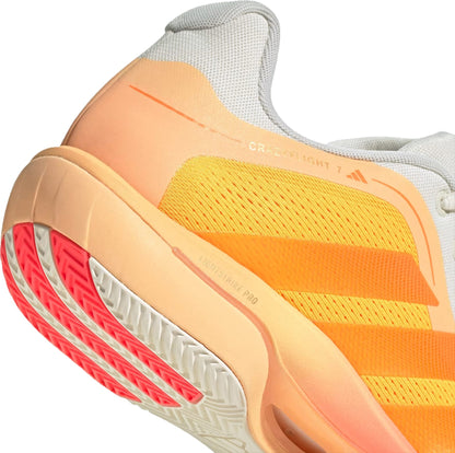 Close-up of the adidas Crazyflight 7 Indoor Men's Padel Shoes in Lucid Tangerine/Lucid Orange/Off White, showing a yellow mesh upper, orange gradient midsole, red and white outsole, LightstrikePro cushioning, and bold adidas stripes.