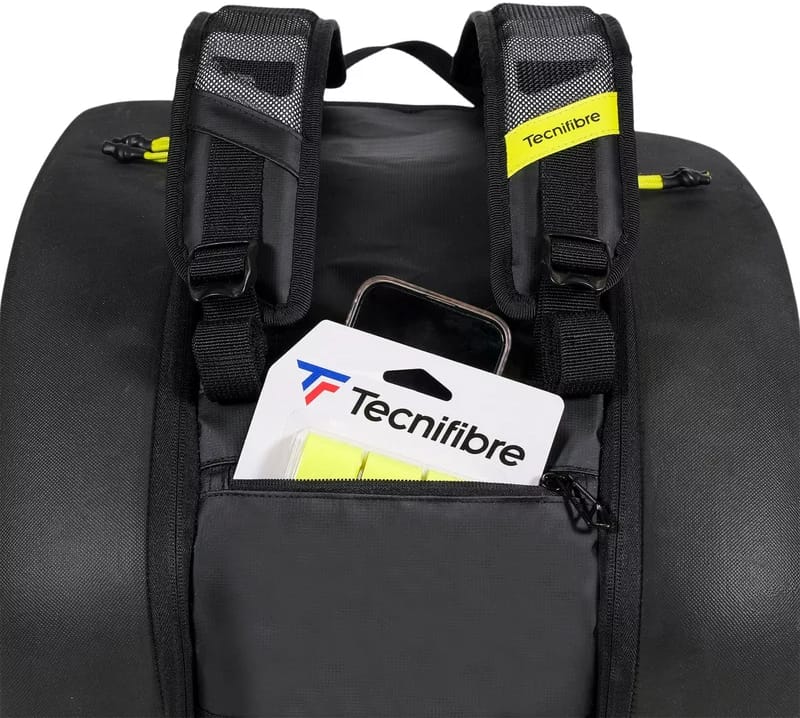 Close-up of the Tecnifibre Reform Padel Racket Bag in black/yellow with padded shoulder straps and a front pocket storing a Tecnifibre package and smartphone, offering reliable racket protection in a stylish, waterproof bag.