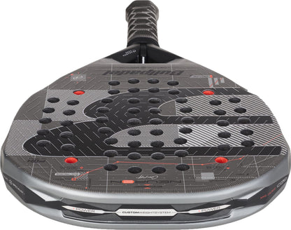 A close-up of the Bullpadel Neuron 02 Comfort 2027 Padel Racket, a black and gray racket by Bullpadel featuring a textured surface, multiple holes, red accents, and a black grip handle—perfect for intermediate and advanced players who want maximum control.
