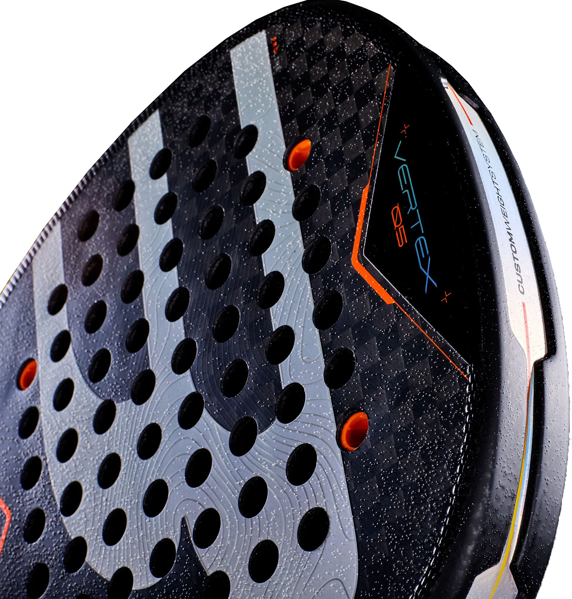 A close-up of the Bullpadel Vertex 05 2027 Padel Racket—an elite black padel racket with circular holes, striking orange accents, and “VERTEX 05” displayed on its surface. The glossy texture showcases the advanced X-Tend Carbon 12K construction that defines this high-performance model from Bullpadel, trusted by top players like Juan Tello.