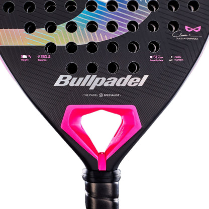 A detailed close-up of the Bullpadel Wonder 2027 Padel Racket in black, featuring pink and rainbow accents, circular perforations, and Bullpadel branding with signature and specifications displayed against a white background. This advanced Bullpadel racket seamlessly blends striking style with high performance for committed padel players.